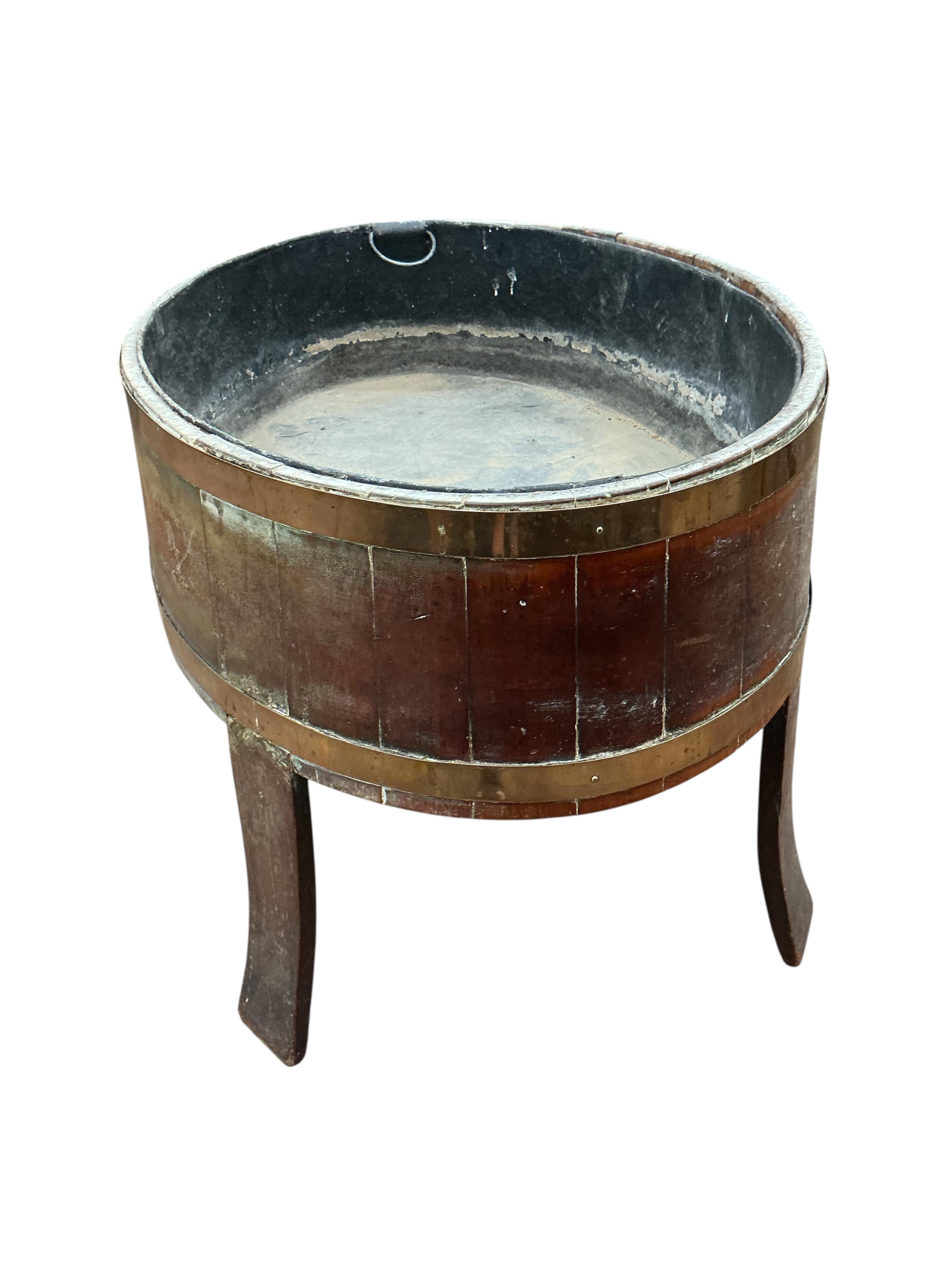 A George III brass bound staved mahogany oval wine cooler, width 92cm, depth 65cm, height 56cm